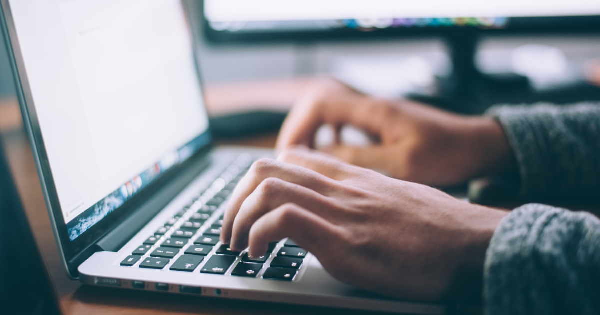 Man typing on laptop